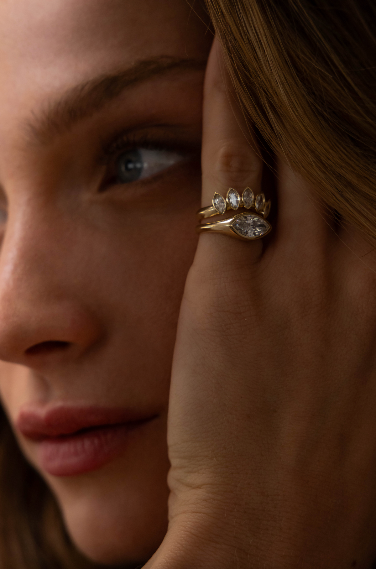 Marquise signet ring held beside a mirror