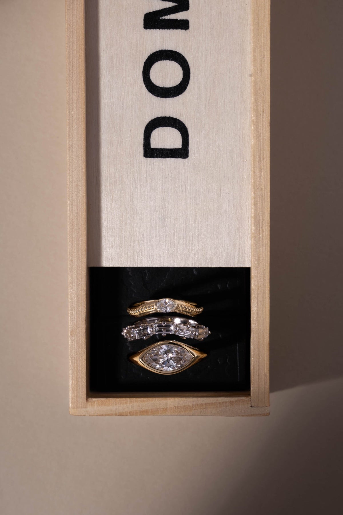 Three ARISH rings arranged in a wooden box